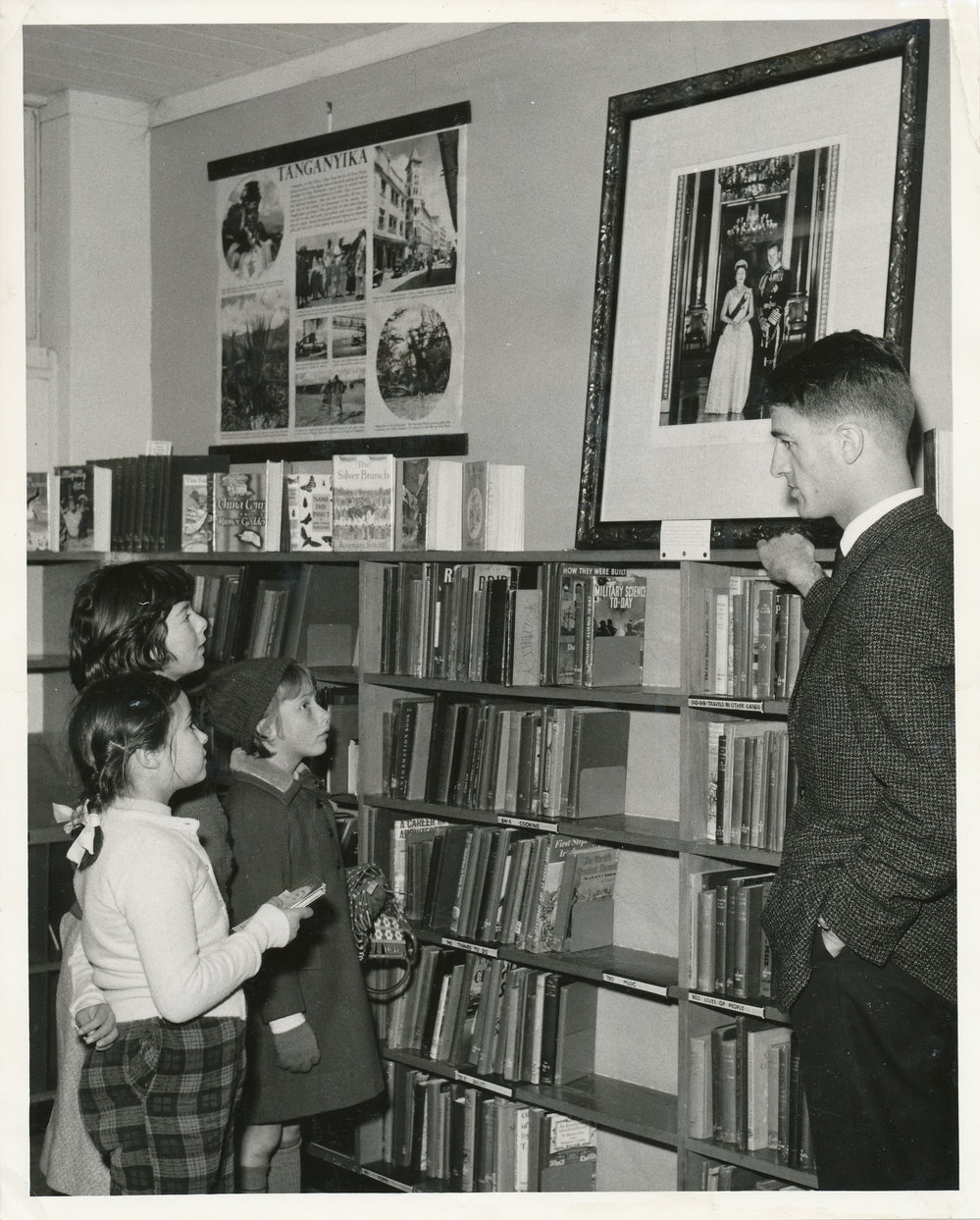 Elizabeth Librarian, Warwick Dunstan with portrait of Queen Elizabeth and Duke of Edinburgh, July 1963