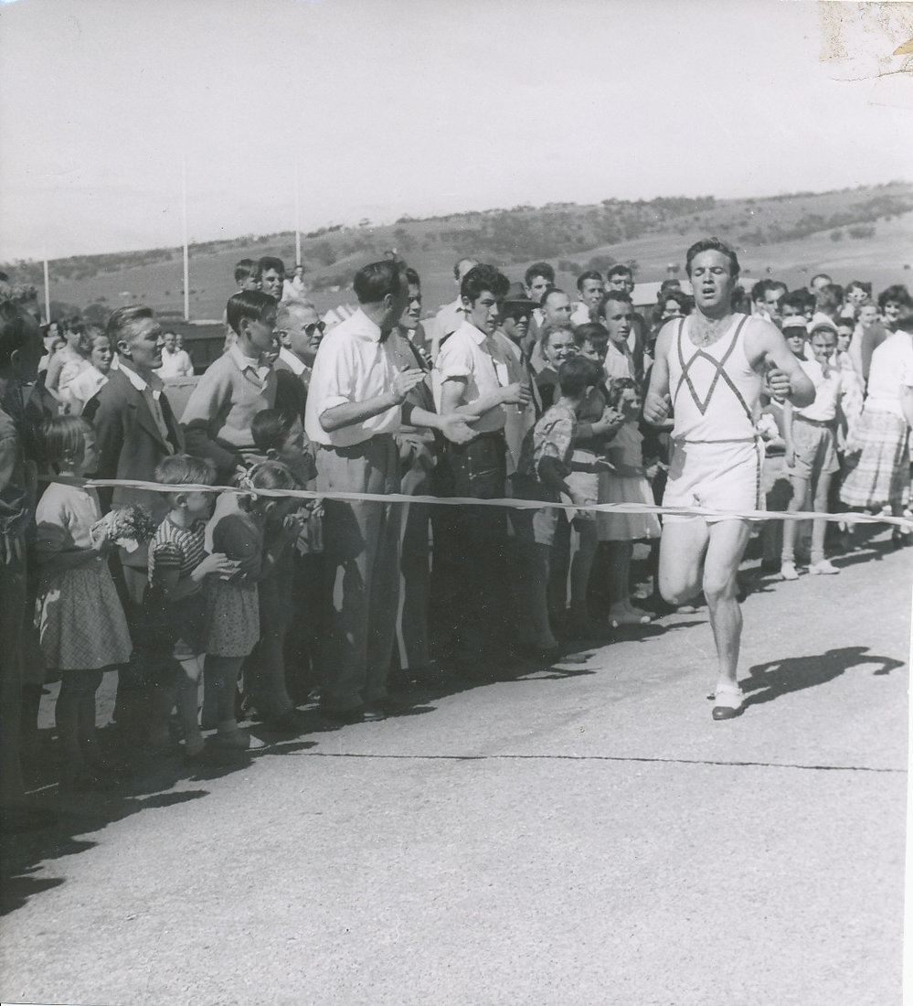 Tommy Brooks crossing the finishing line of the first "Elizabeth Mile"